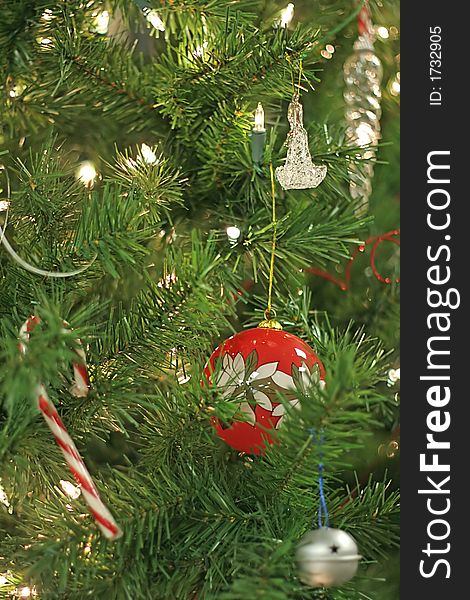 Red Christmas ornament on decorated tree. Red Christmas ornament on decorated tree