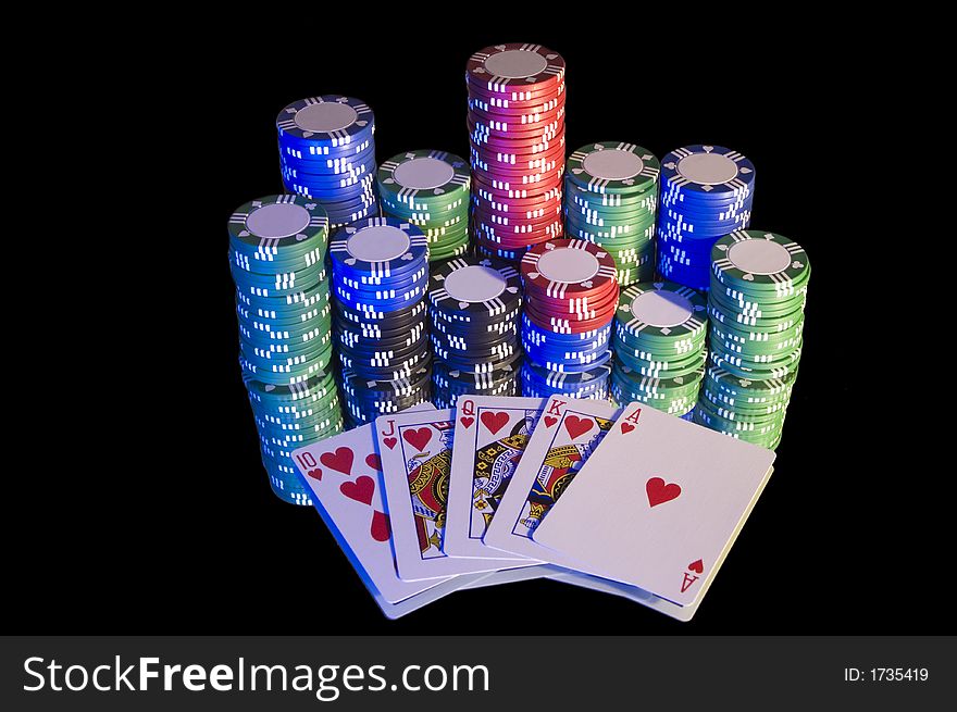 Royal Flush, hearts, with chips. Blue lighting from left hand side, isolated on black.
