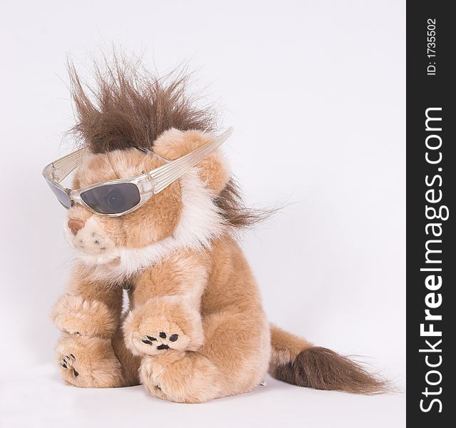 Cute stuffed lion with a punk hairstyle and sunglasses. Cute stuffed lion with a punk hairstyle and sunglasses