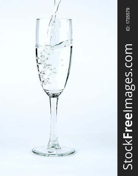 Puring water in glass, isolated on gradient background. Puring water in glass, isolated on gradient background