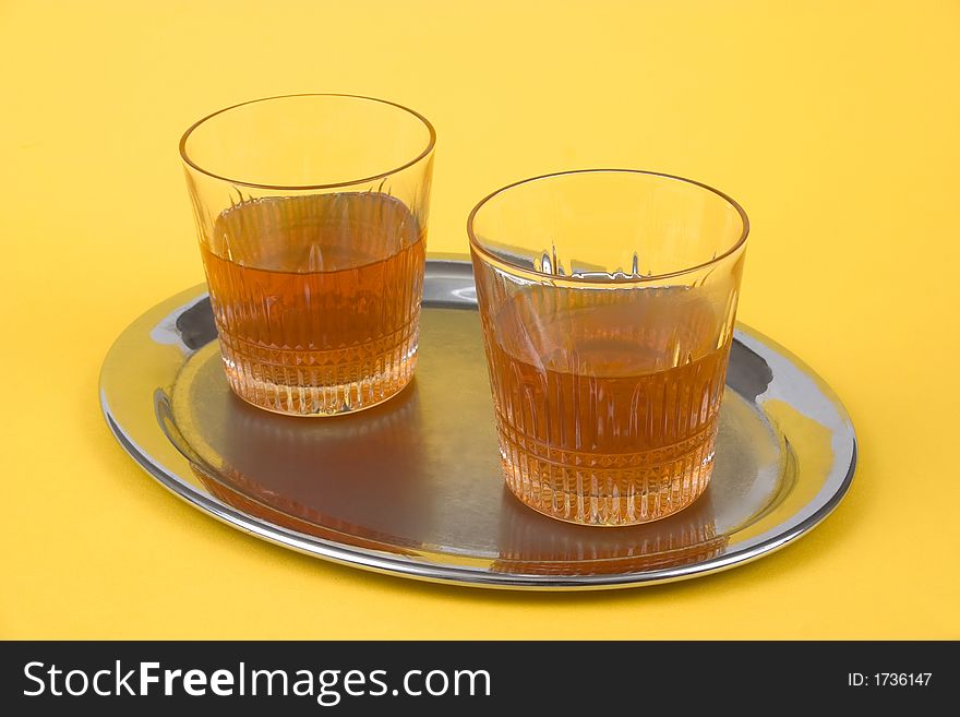 Two Glasses With Whiskey Standing On A Silver Tray