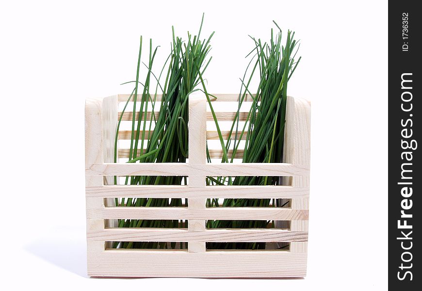 Spring onions leaf on wood box over white background