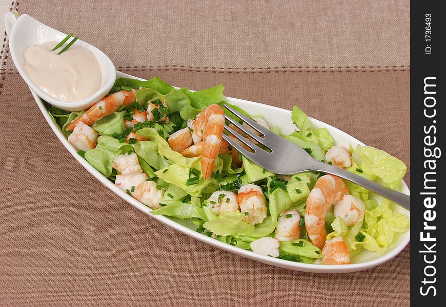 Shrimp salad in a white exclusives plates with sauce