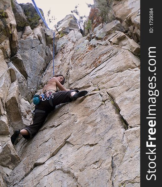 Women rock climbing in dihedral