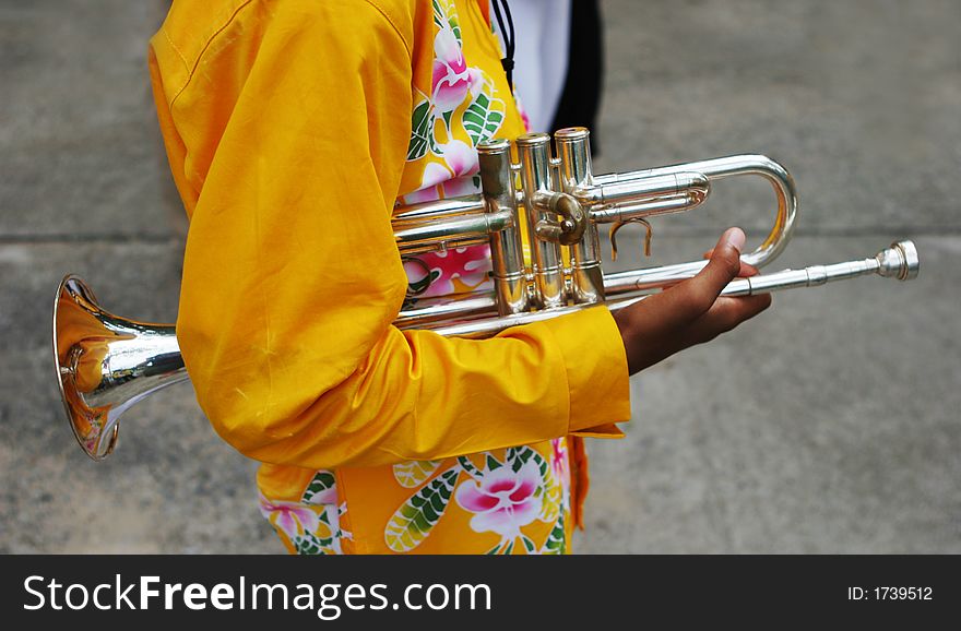 Close-up of a younng band member holding a trumpet