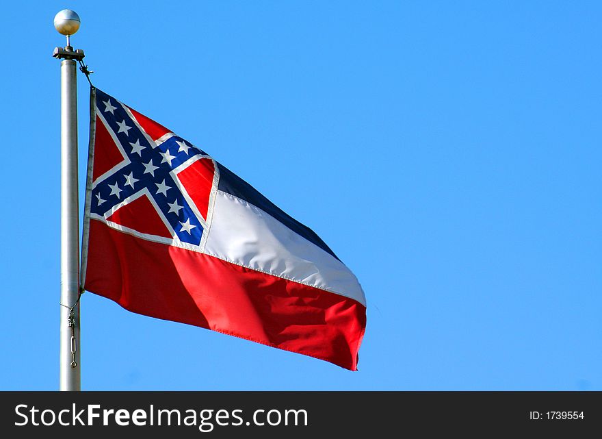 The state flage of Mississippi against a blue sky. The state flage of Mississippi against a blue sky.