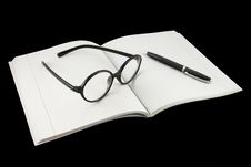 Spectacles Under The Notebook Stock Photo