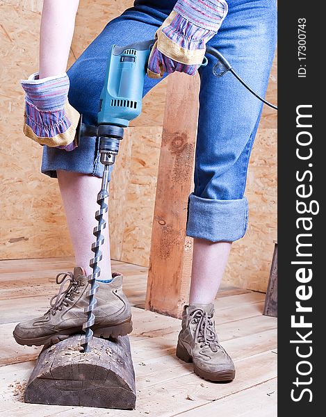 Drill and aperture in a wooden log against wooden walls