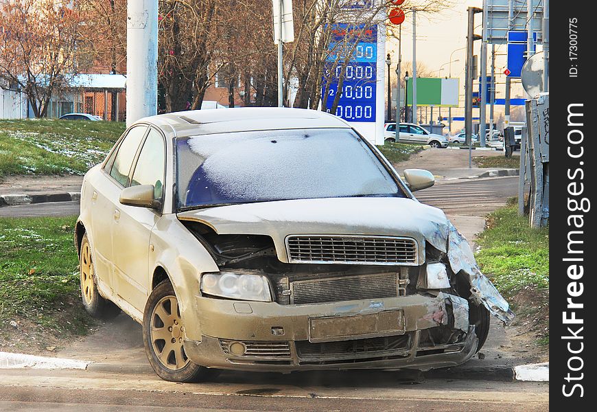 The image of crashed car stands on a sidewalk