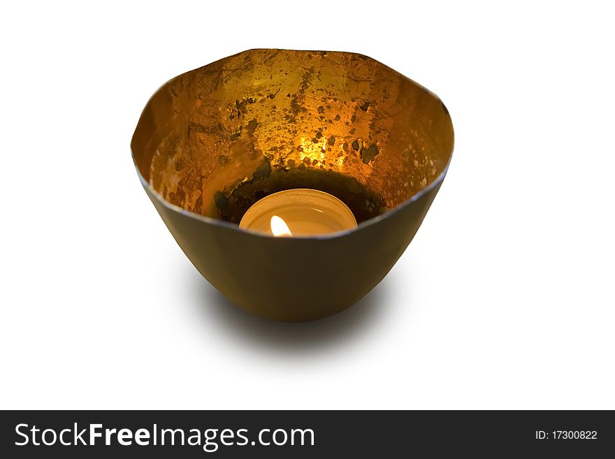 Tea candle in shiny metal cup