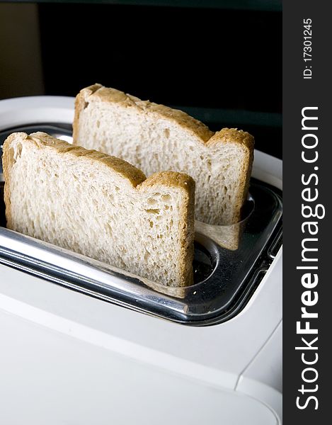 Wheat breads prepare on white toaster. Wheat breads prepare on white toaster.
