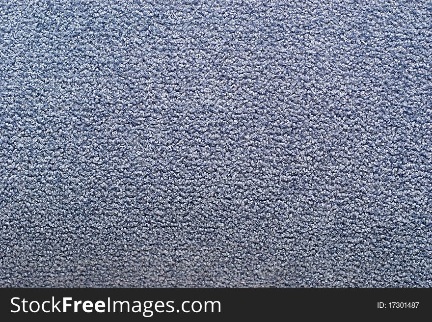 The background of textured blue synthetic fabric closeup