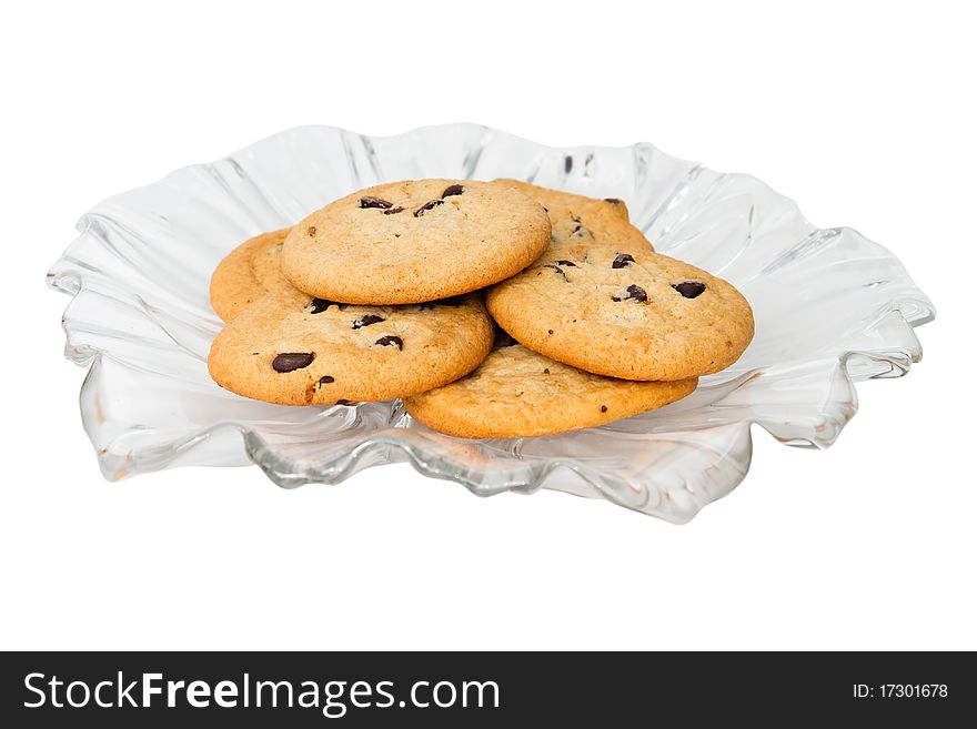 A selection of chocolate chip cookies on a decorative glass plate.