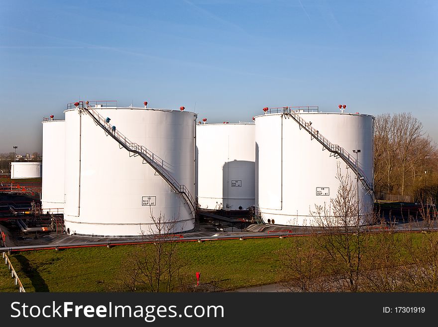 White Tanks In Tank Farm With Blue Sky