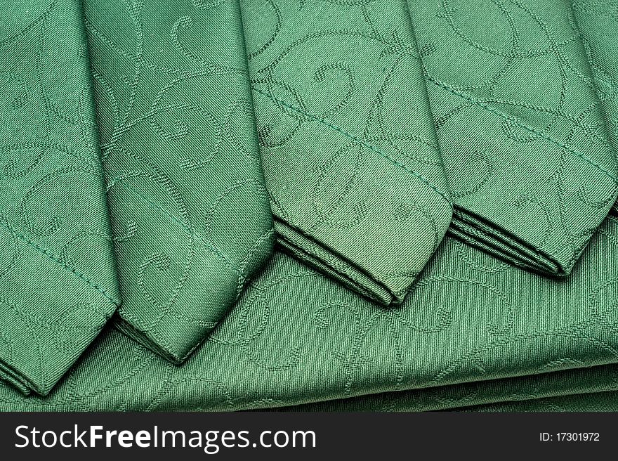 The background of textured green tablecloth and napkin closeup