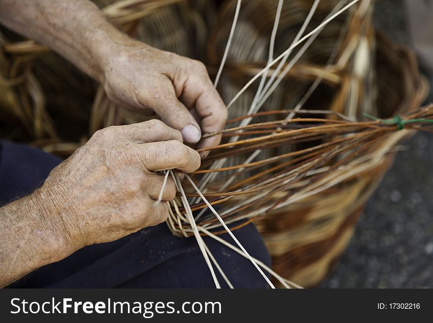 Old hands working in a basket costruction. Old hands working in a basket costruction