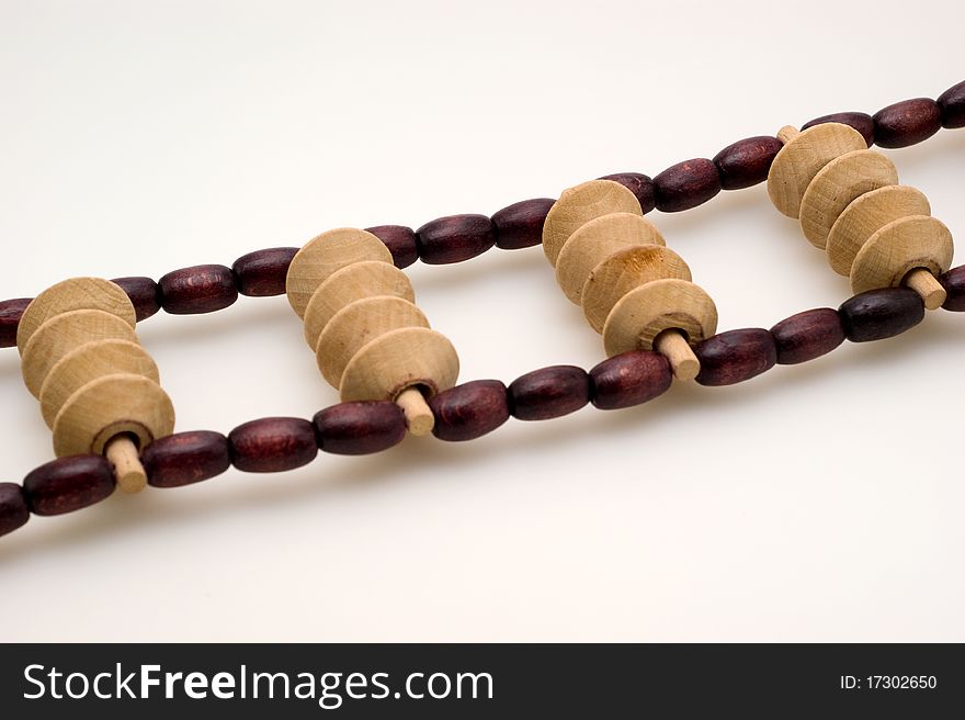 Wooden roller massager on a white background closeup