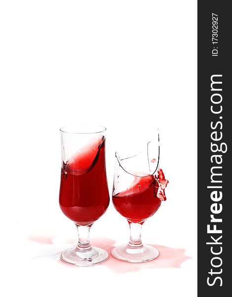 Two glasses with wine and drops ,isolated on white background .one  glass is broken. Two glasses with wine and drops ,isolated on white background .one  glass is broken