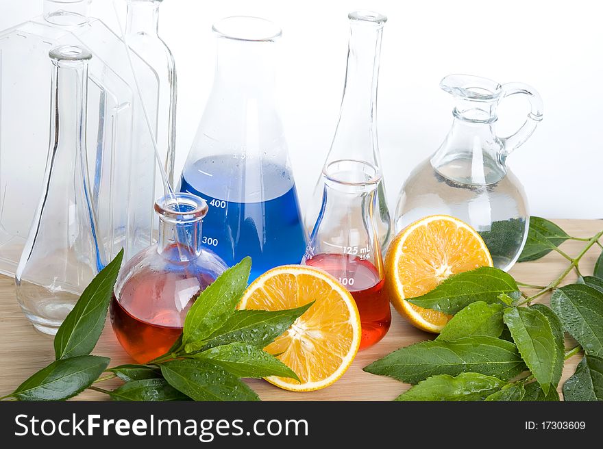 Laboratory flask isolated with fresh orange. Laboratory flask isolated with fresh orange