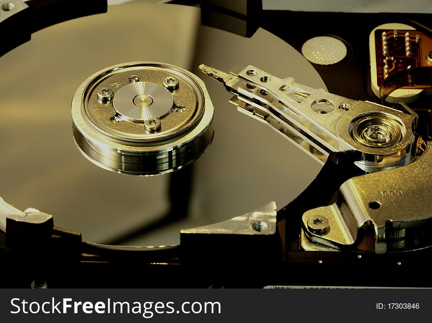 Close view detail of the inside of a computer harddisk isolated on a white background. Close view detail of the inside of a computer harddisk isolated on a white background.