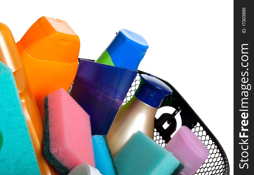 Basket full of plastic bottles for cleaning supplies, lotion, shampoo etc. isolated on white background. (A shopping)