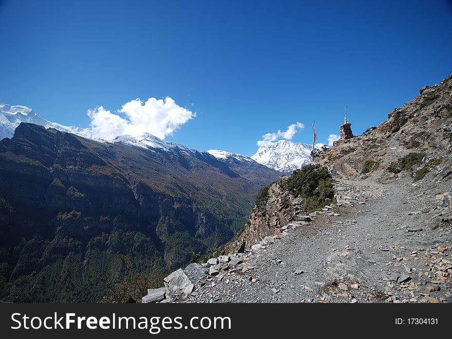 Path and snow mountains in the background in Nepal