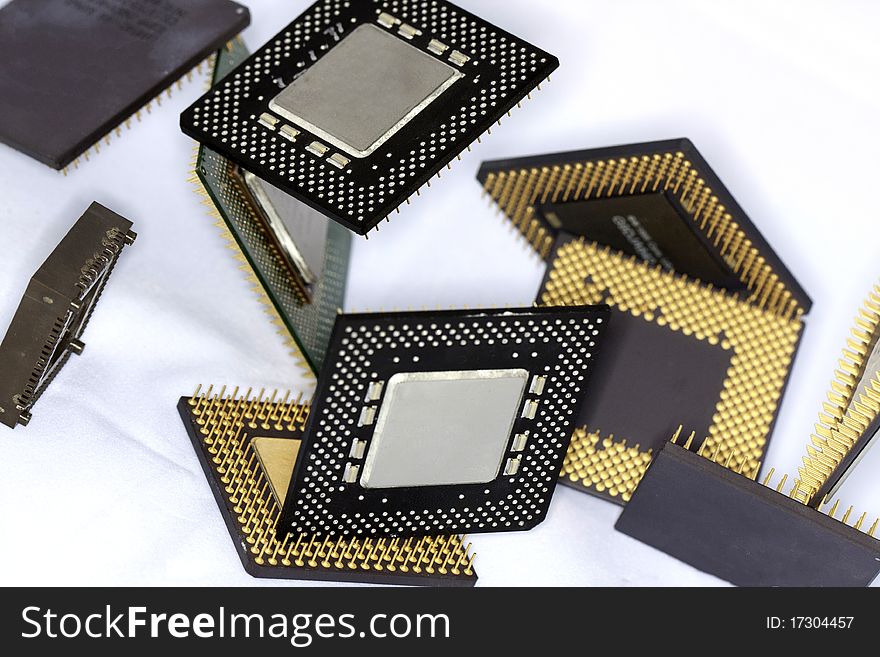 Close view detail of some computer microprocessors isolated on a white background.