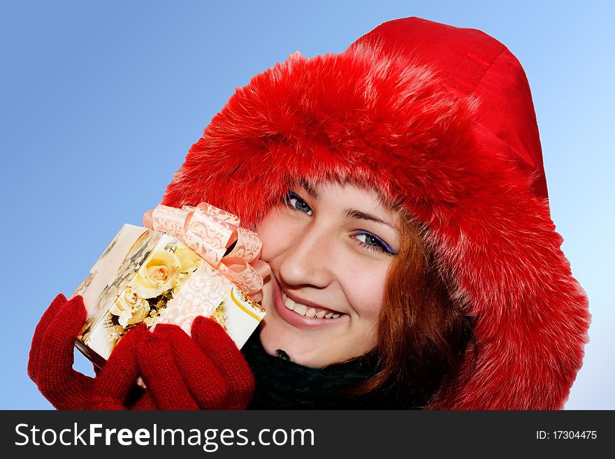Portrait Of A Smiling Young Woman Giving A Gift