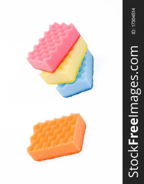 One and a few varicoloured bath sponges isolated on a white background