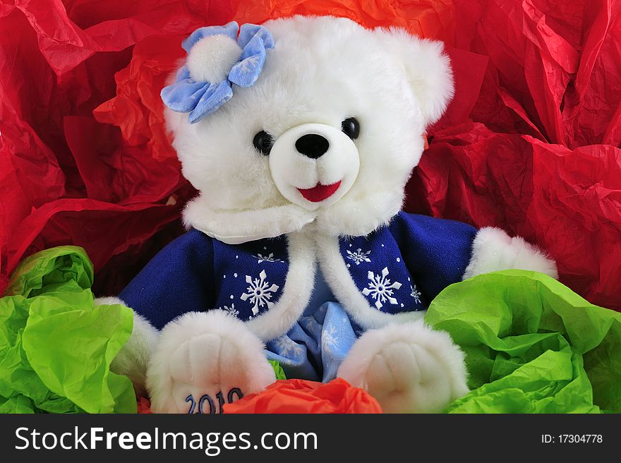 Teddy bear with blue coat and bow