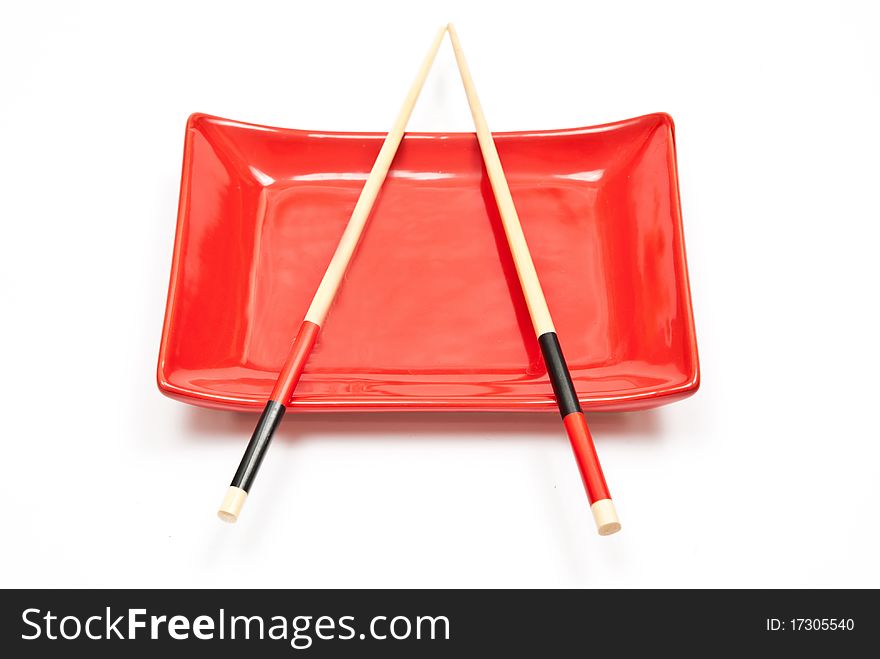 Black and red sushi set (chopsticks and plate) isolated on white background