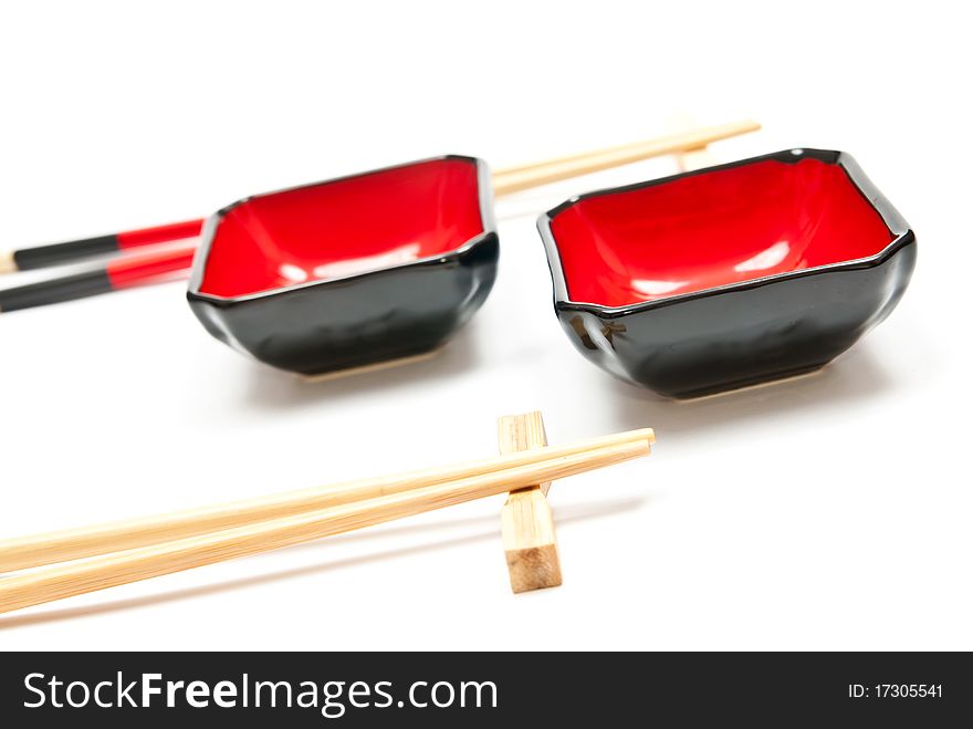 Black and red sushi set (chopsticks and plate) isolated on white background. Black and red sushi set (chopsticks and plate) isolated on white background