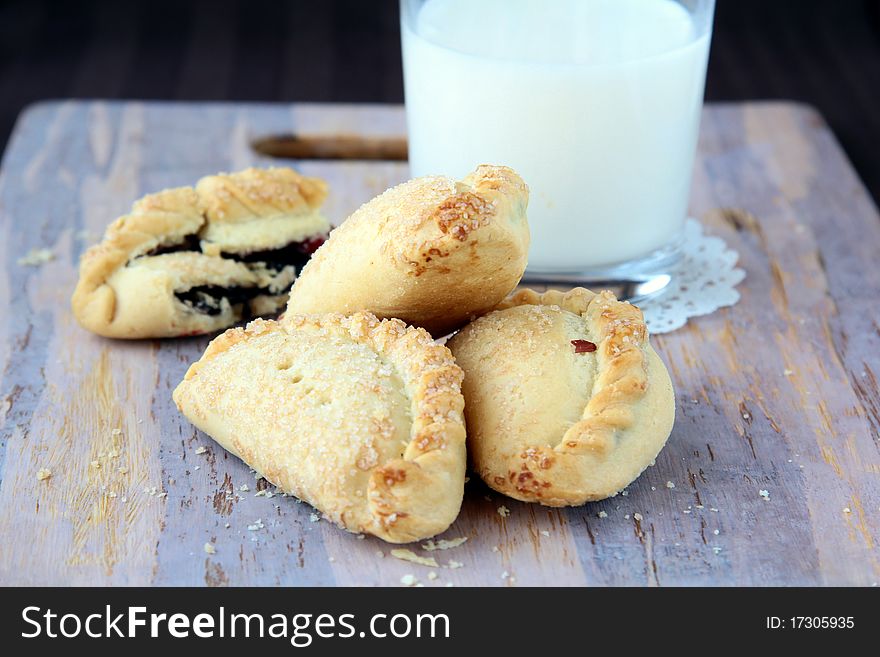 Buns with milk on a wooden board