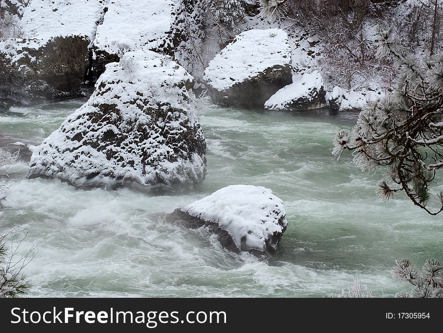 Snow lays heavily over the boulders in the Spokane River, Washington. Snow lays heavily over the boulders in the Spokane River, Washington