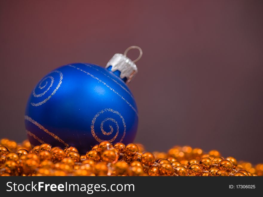 Christmas decoration with goden beaded garland and blue globe