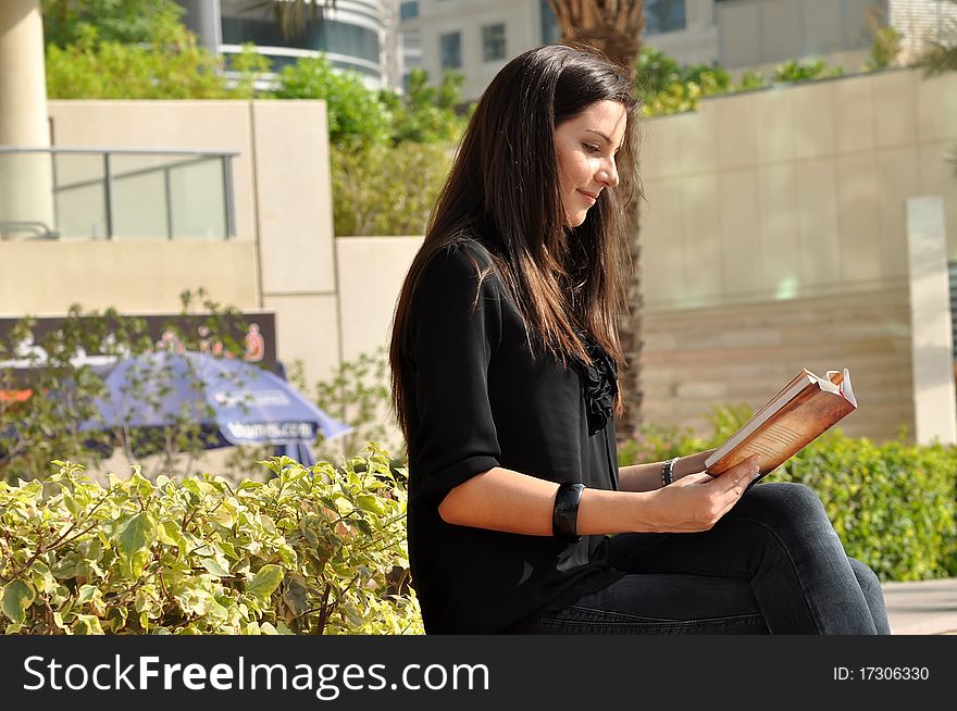 Young Beautiful Woman Reading A Book