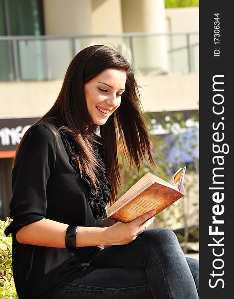 Young beautiful woman reading a book