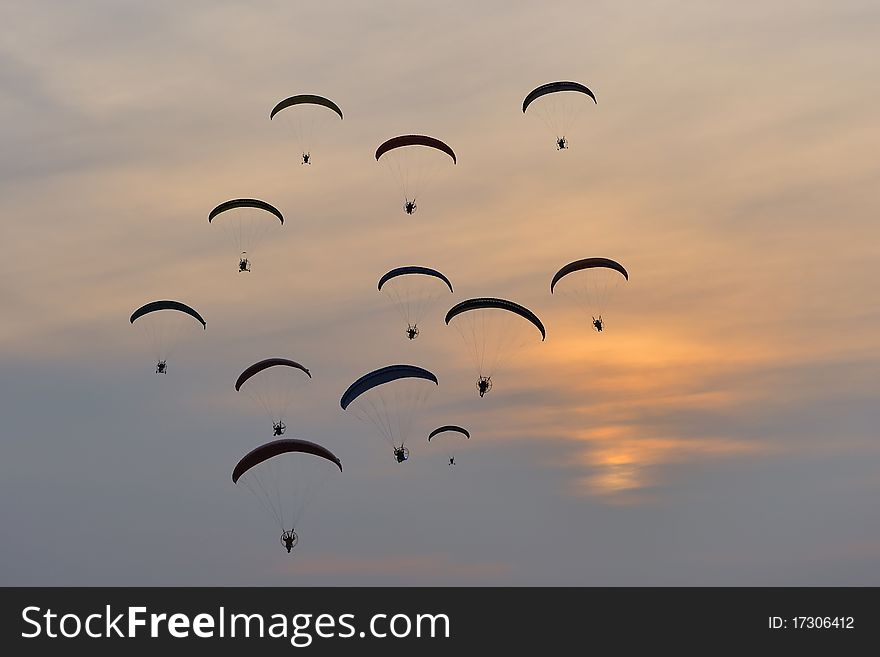 Group of paramotors flying at sunset. Group of paramotors flying at sunset