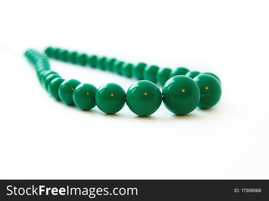 Beautiful bright green beads on a white background
