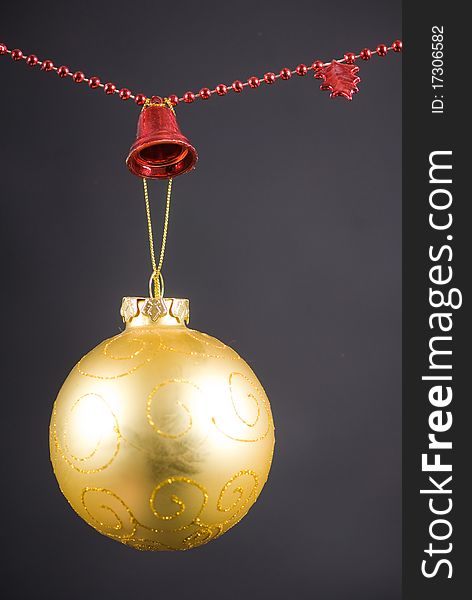 Christmas decoration with golden globe and red beaded garland