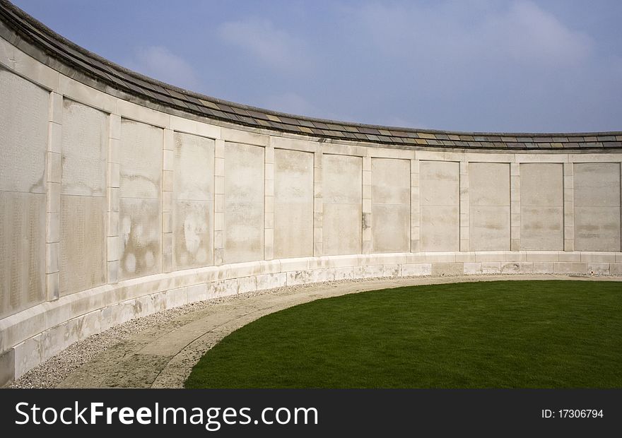 A curved white memorial wall bearing the names of soldiers who died in the first world war in Europe. A curved white memorial wall bearing the names of soldiers who died in the first world war in Europe