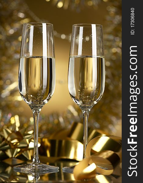 Champagne in glasses on a yellow background. Champagne in glasses on a yellow background