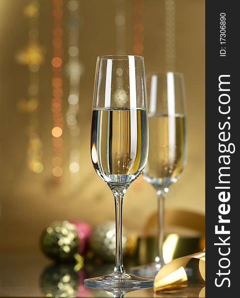 Champagne in glasses on a yellow background. Champagne in glasses on a yellow background