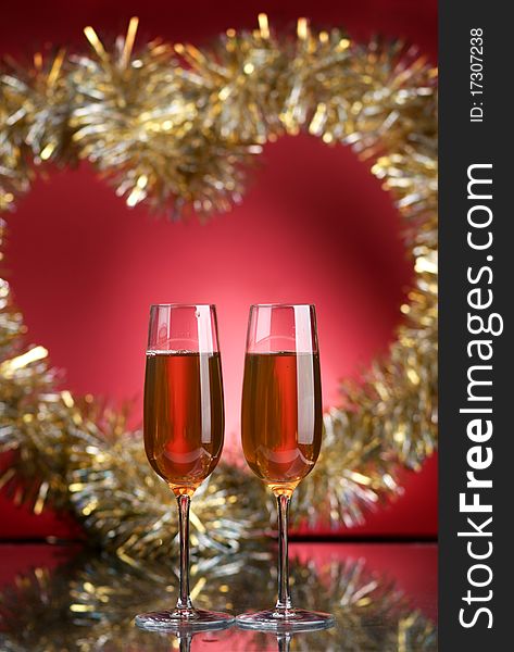 Champagne in glasses on a red background. Champagne in glasses on a red background
