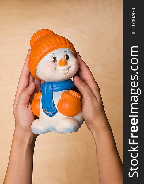 Toy snow man on the hands of child. Toy snow man on the hands of child