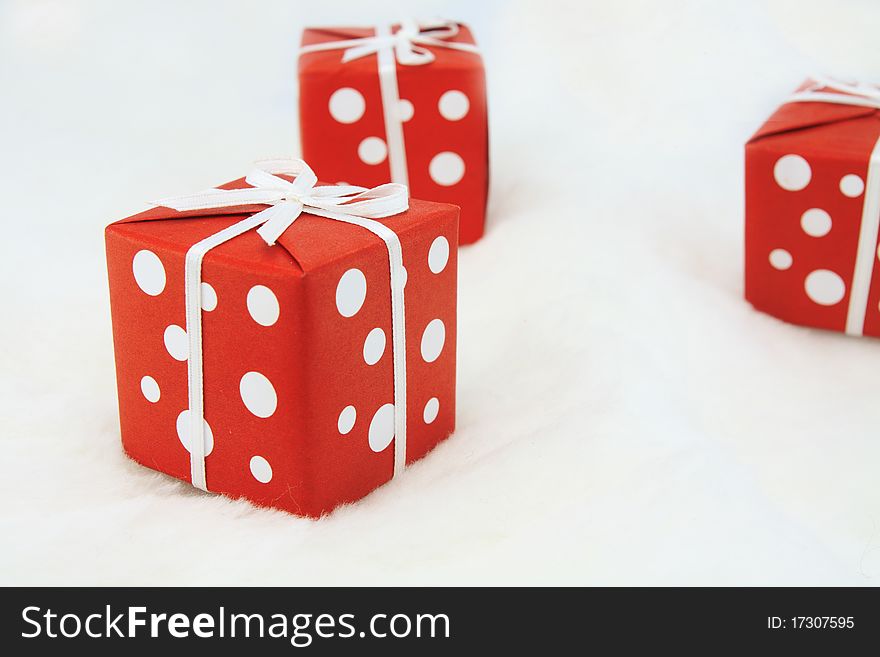 Three Red wrapped gifts on white