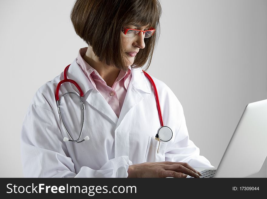 Portrait of a female doctor with laptop