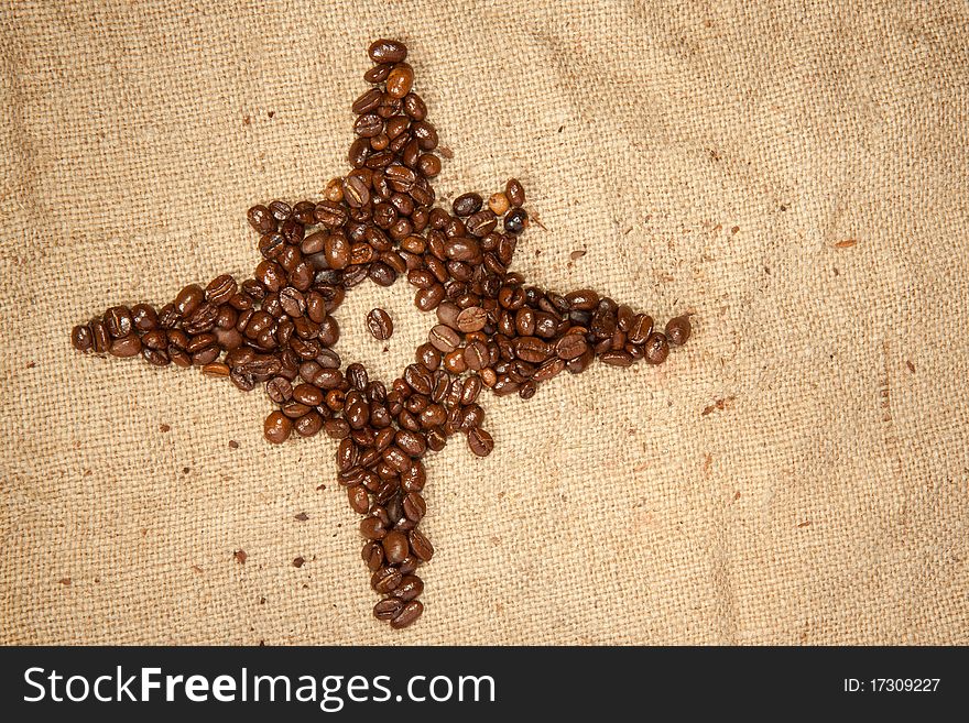 Fragrant fried coffee beans as the star on the jute. Fragrant fried coffee beans as the star on the jute