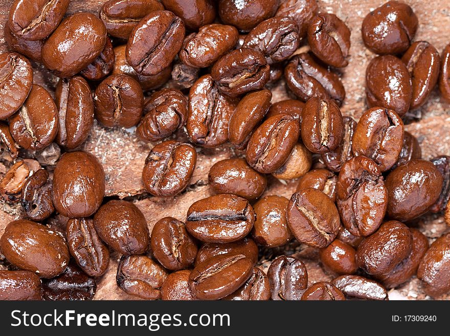 Background of fragrant fried coffee beans on the wood. Background of fragrant fried coffee beans on the wood