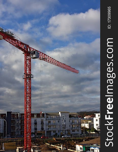 An image of a high red crane against the blue sky background. An image of a high red crane against the blue sky background